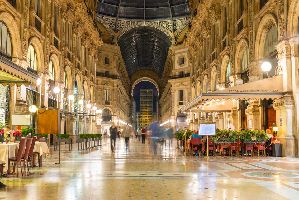 Por la noche, la Galería Vittorio Emanuele II se ilumina con luces.